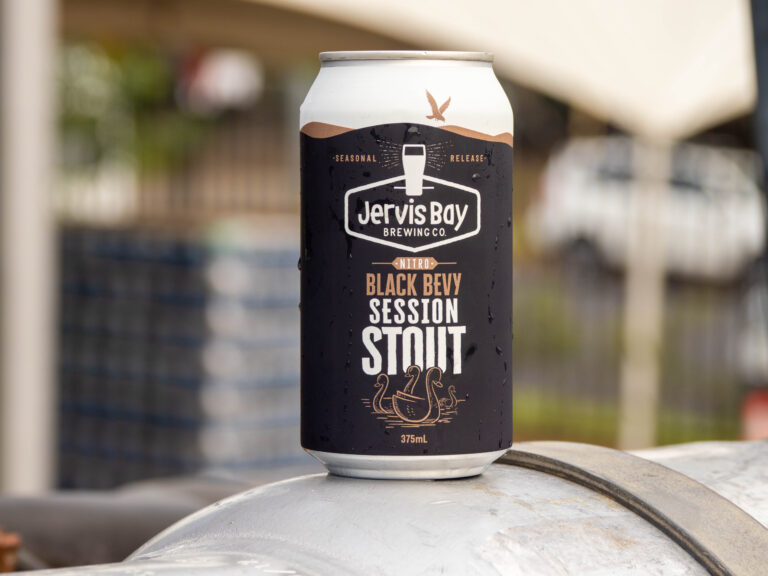 Can of beer, mostly black with white top.